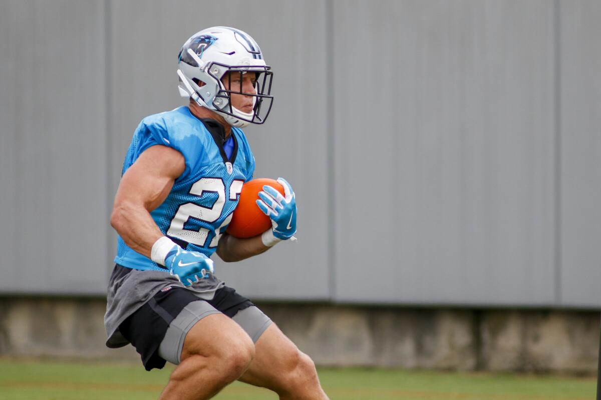 Carolina Panthers running back Christian McCaffrey carries the ball during a team practice session in August.