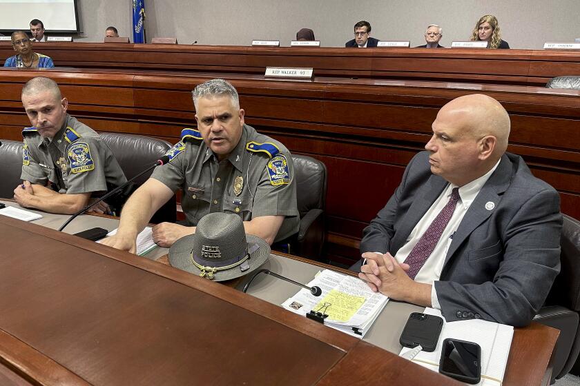 FILE - Connecticut Department of Emergency Services and Public Protection Commissioner James Rovella, right, appears with Col. Stavros Mellekas, superintendent of the Connecticut State Police, center, and Lt. Col. Mark Davison for a hearing on state troopers providing false traffic stop information on Wednesday, July 26, 2023, in Hartford, Conn. Rovella and Mellekas will be stepping down in the middle of multiple investigations into whether troopers submitted bogus data on thousands of traffic stops that may have never happened, Gov. Ned Lamont announced Wednesday, Oct. 4, 2023. (AP Photo/File File)