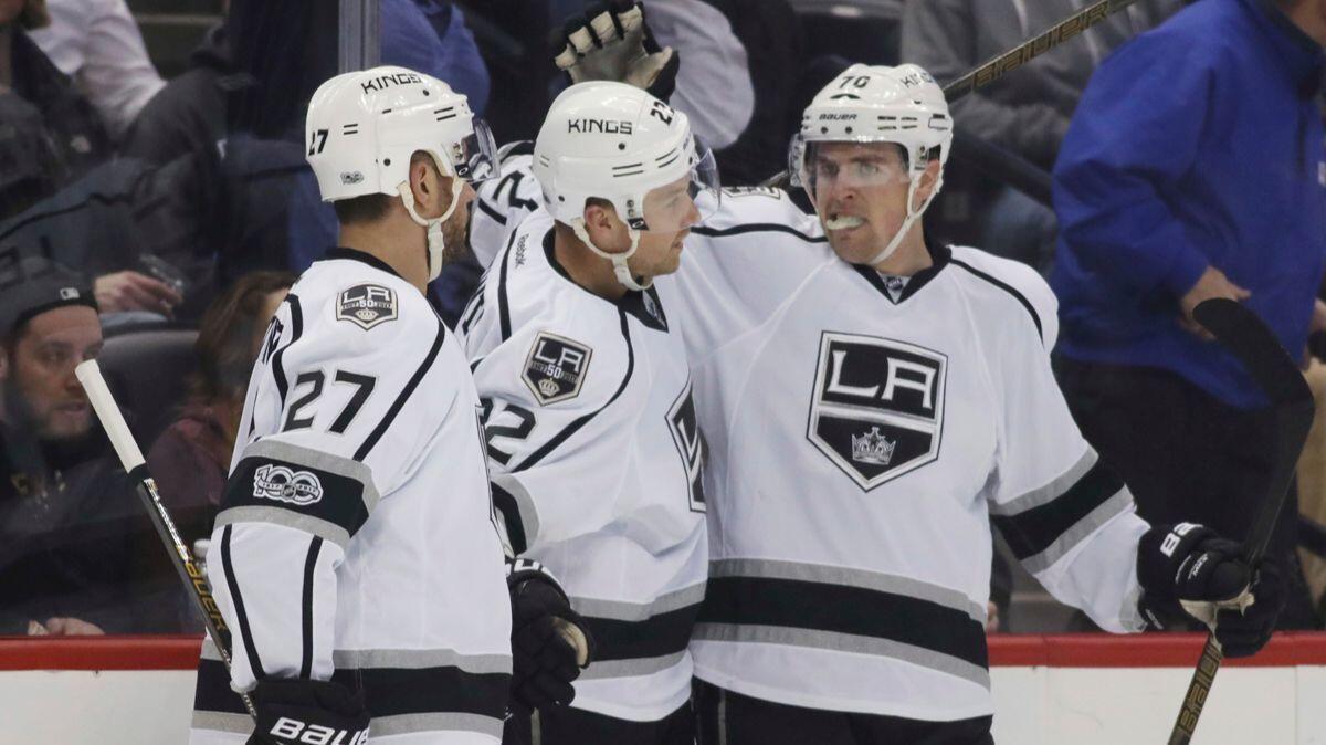 Kings center Trevor Lewis, center, is congratulated after scoring a goal by defenseman Alec Martinez, left, and left wing Tanner Pearson against the Colorado Avalanche in the second period Tuesday.