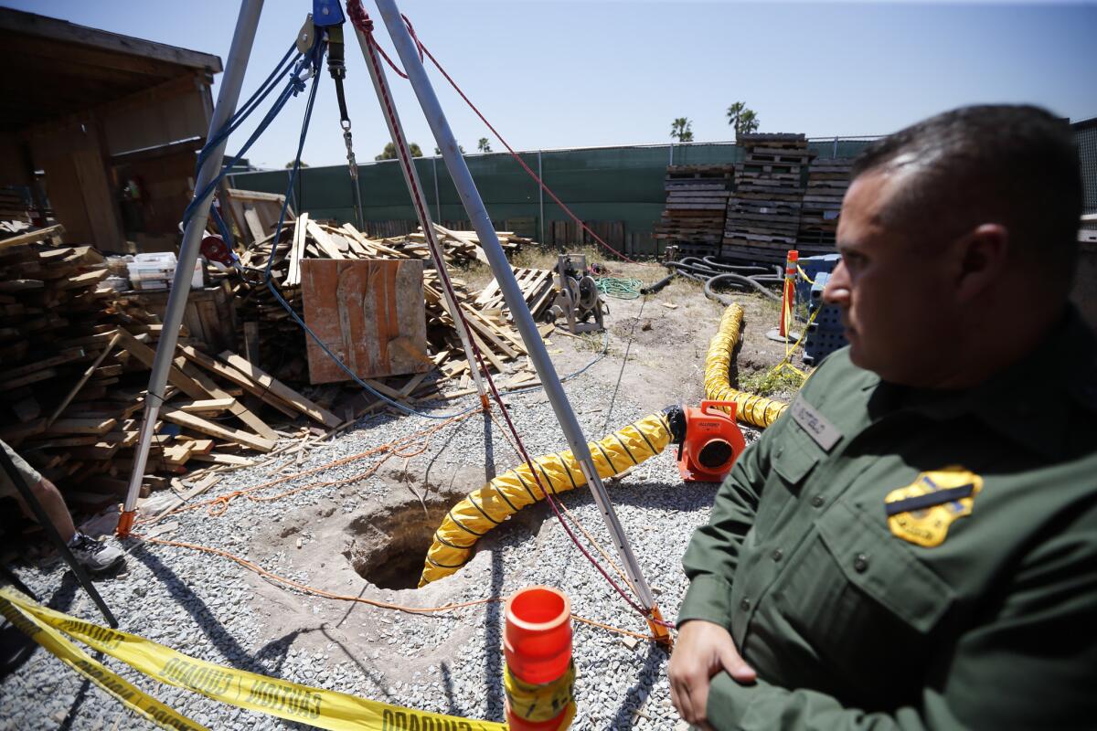 Border Patrol Special Operations Supervisor Cesar Sotelo looks toward the entrance of a recently discovered tunnel leading from Mexico to San Diego.