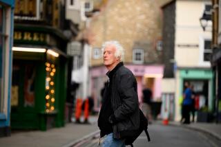 Renowned, two-time Oscar-winning cinematographer Sir Roger Deakins crosses an English street.