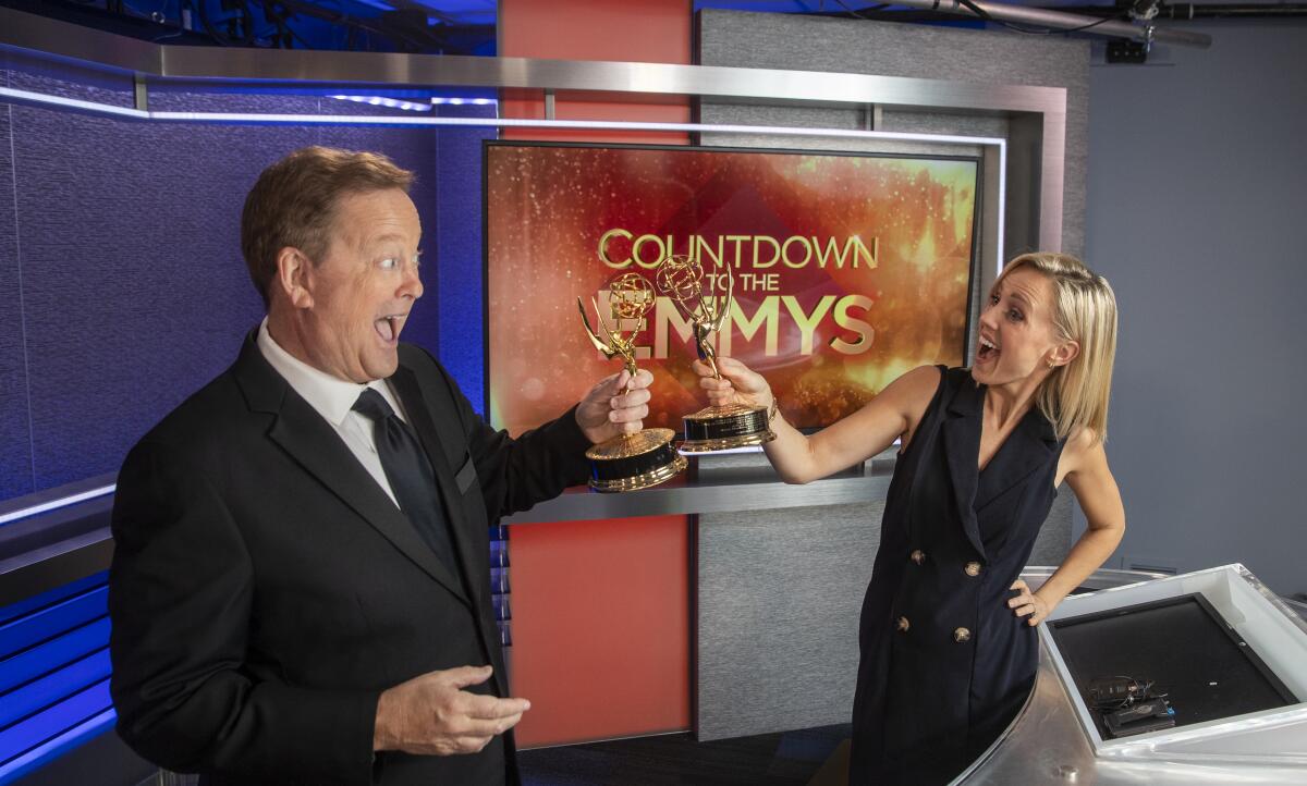 KTLA's Sam Rubin and Jessica Holmes with Emmy Awards.