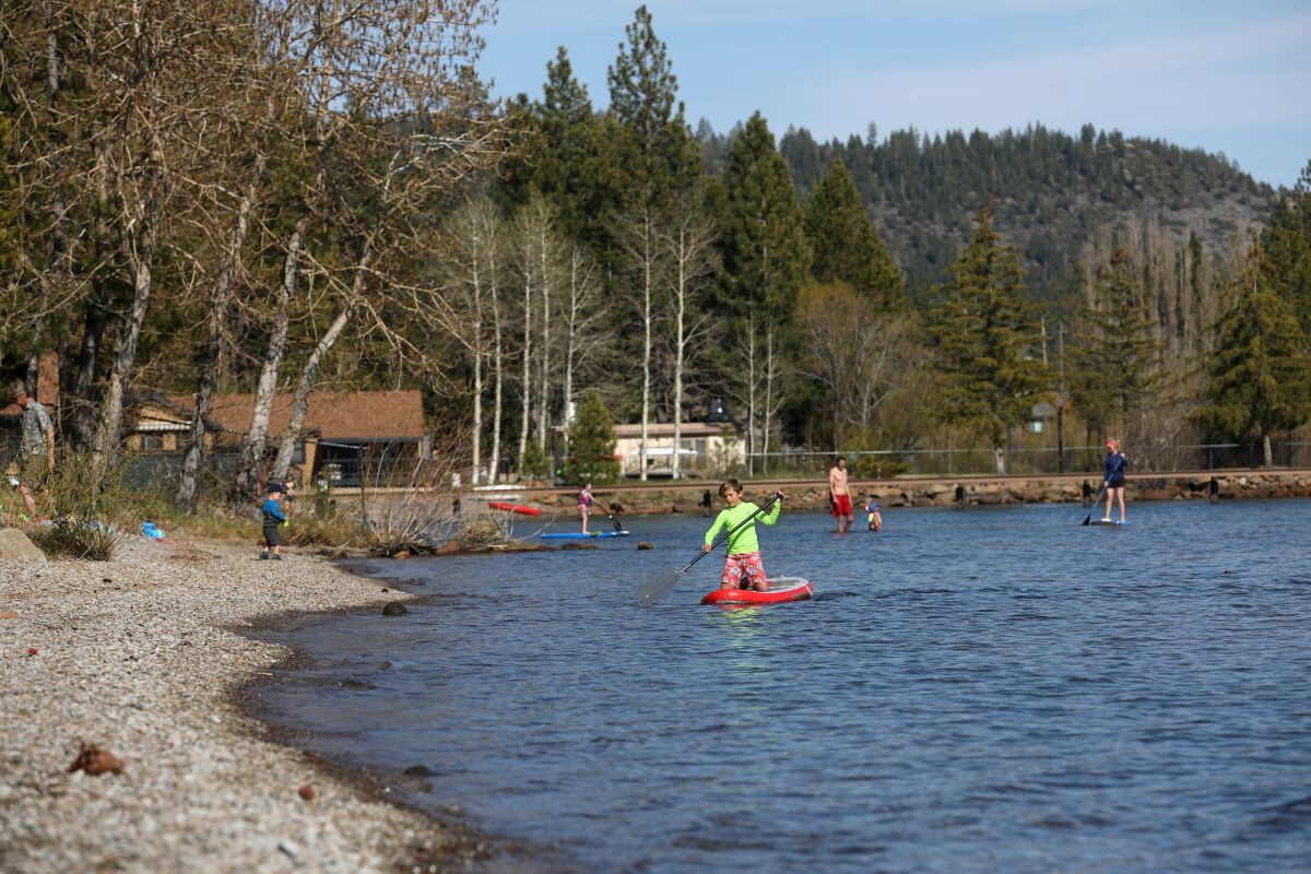 People enjoy the public beach on the north shore of Lake Tahoe in Tahoe Vista.