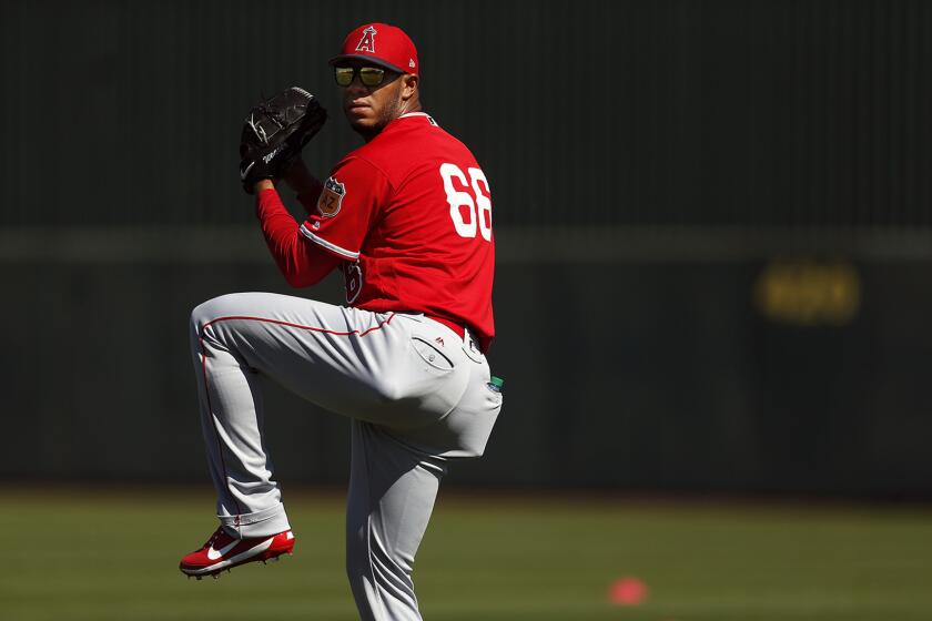 Angels relief pitcher J.C. Ramirez warms up during spring training on Feb. 24 at Tempe Diablo Stadium.