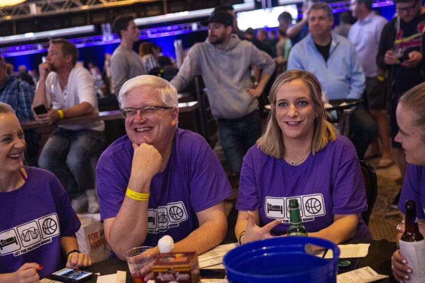 LAS VEGAS, NEV. - MARCH 22: The Lankfords of Kansas City, Mo., (L-R) Paige Lankford, 23, lan Lankford, 57, Stephanie Lankford-Scovill, 28, and Megan Lankford, 25, watch NCAA March Madness basketball games at The Cosmopolitan's Hoops & Hops event on Friday, March 22, 2019 in Las Vegas, Nev. (Kent Nishimura / Los Angeles Times)