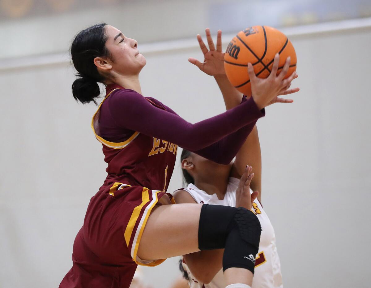 Estancia's Andrea Meza (1) goes up high as she drives past a defender against Ocean View on Wednesday.