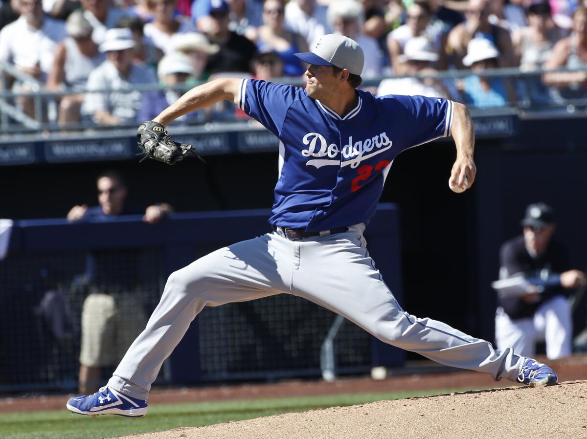 Dodgers starting pitcher Clayton Kershaw prepares to deliver against the Mariners during a spring training game.