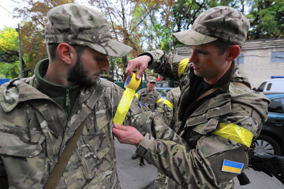 Ukraine soldiers put tape on their arms to identify themselves as comrades in the fight against pro-Russia separatists.