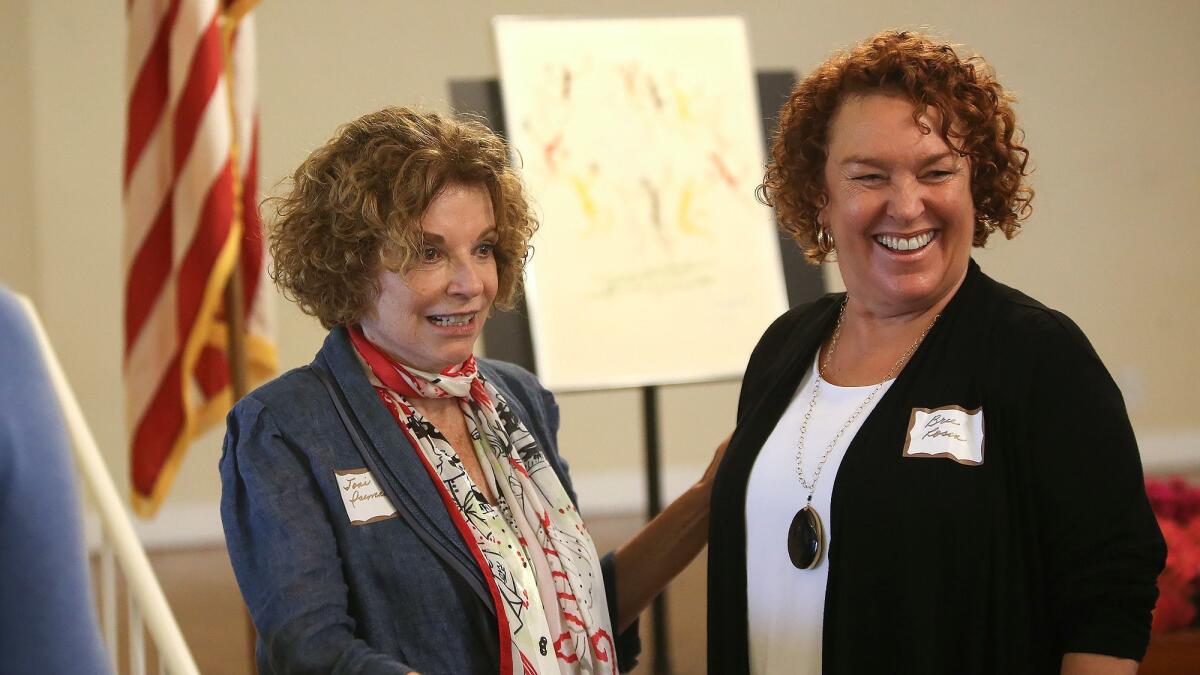 Toni Iseman, left, is greeted by No Square Theatre founding artistic director Bree Burgess Rosen at a luncheon Friday where the Laguna Beach Woman’s Club honored Iseman as Woman of the Year. Iseman is in her sixth consecutive term as a City Council member.
