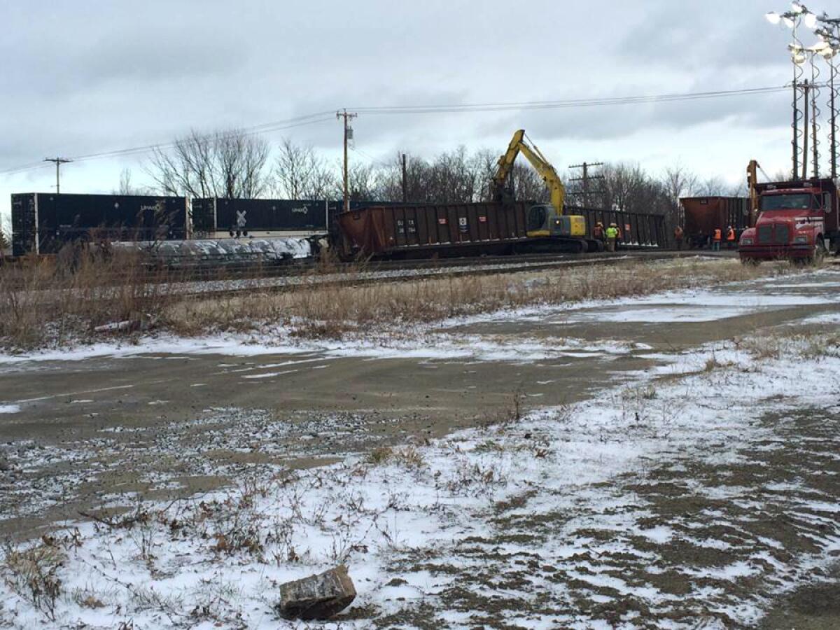 Crews work to clear the site of a Norfolk Southern freight train derailment that forced the evacuation of dozens of western New York homes after ethanol leaked from two tankers.