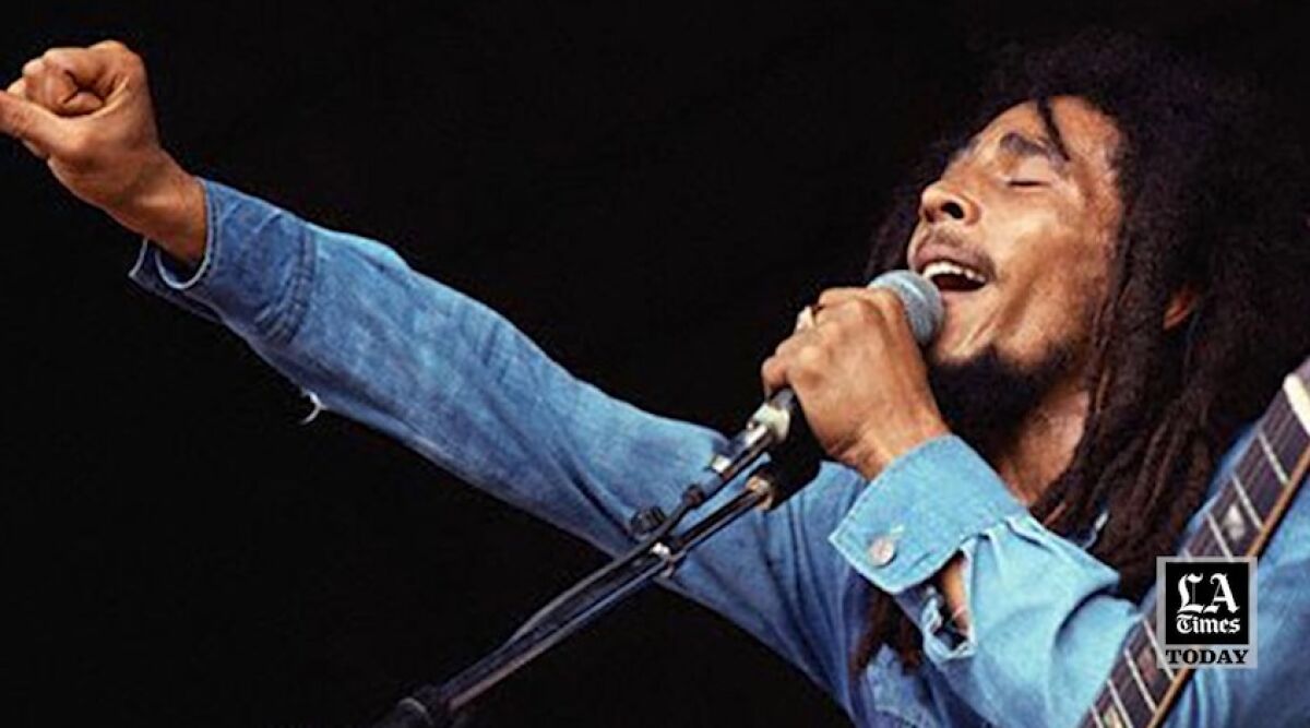 Bob Marley singing with a fist in the air