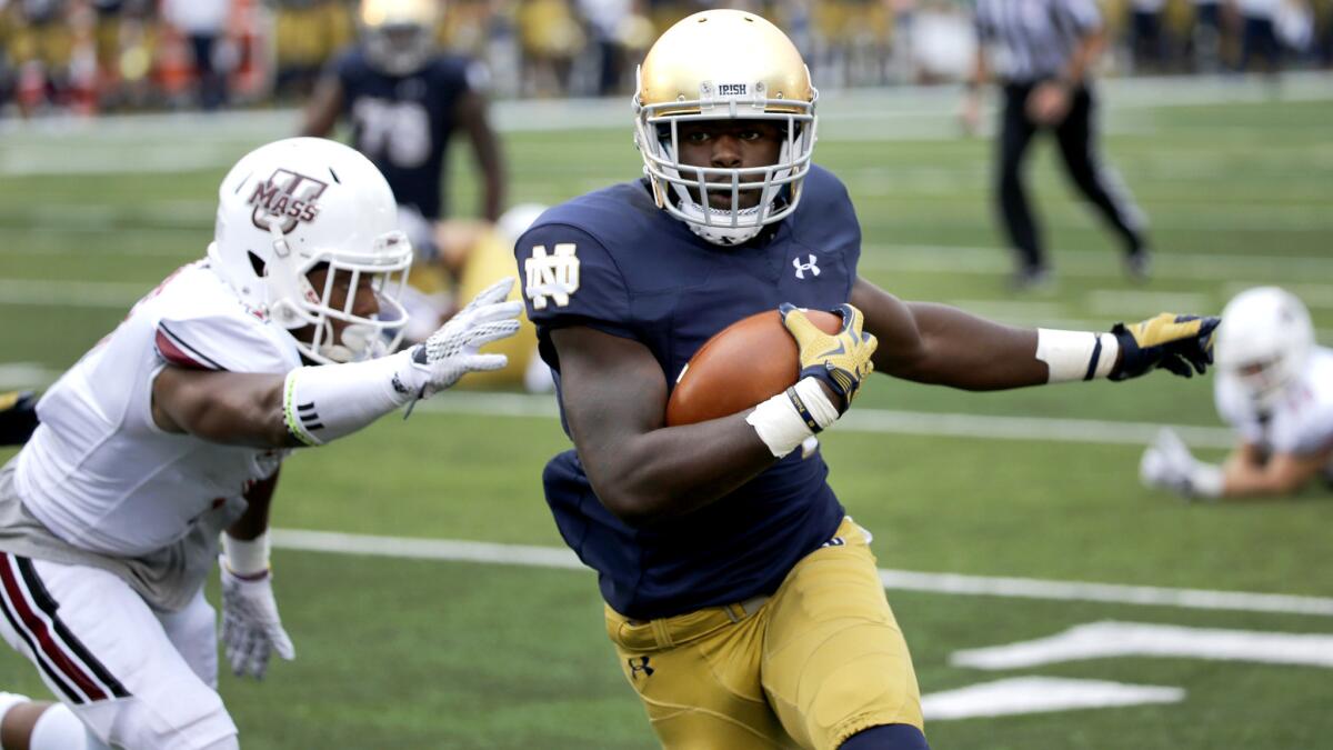 Notre Dame running back Dexter Williams gets past Massachusetts defensive back Randall Jette on a touchdown run in the second half Saturday.