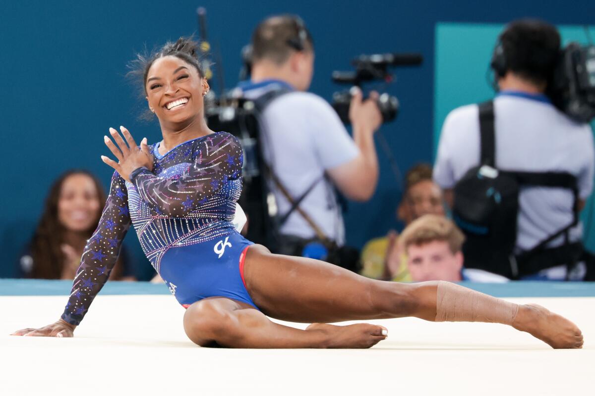 Simone Biles smiles after performing on the floor routine during the gymnastics individual all-around finals.