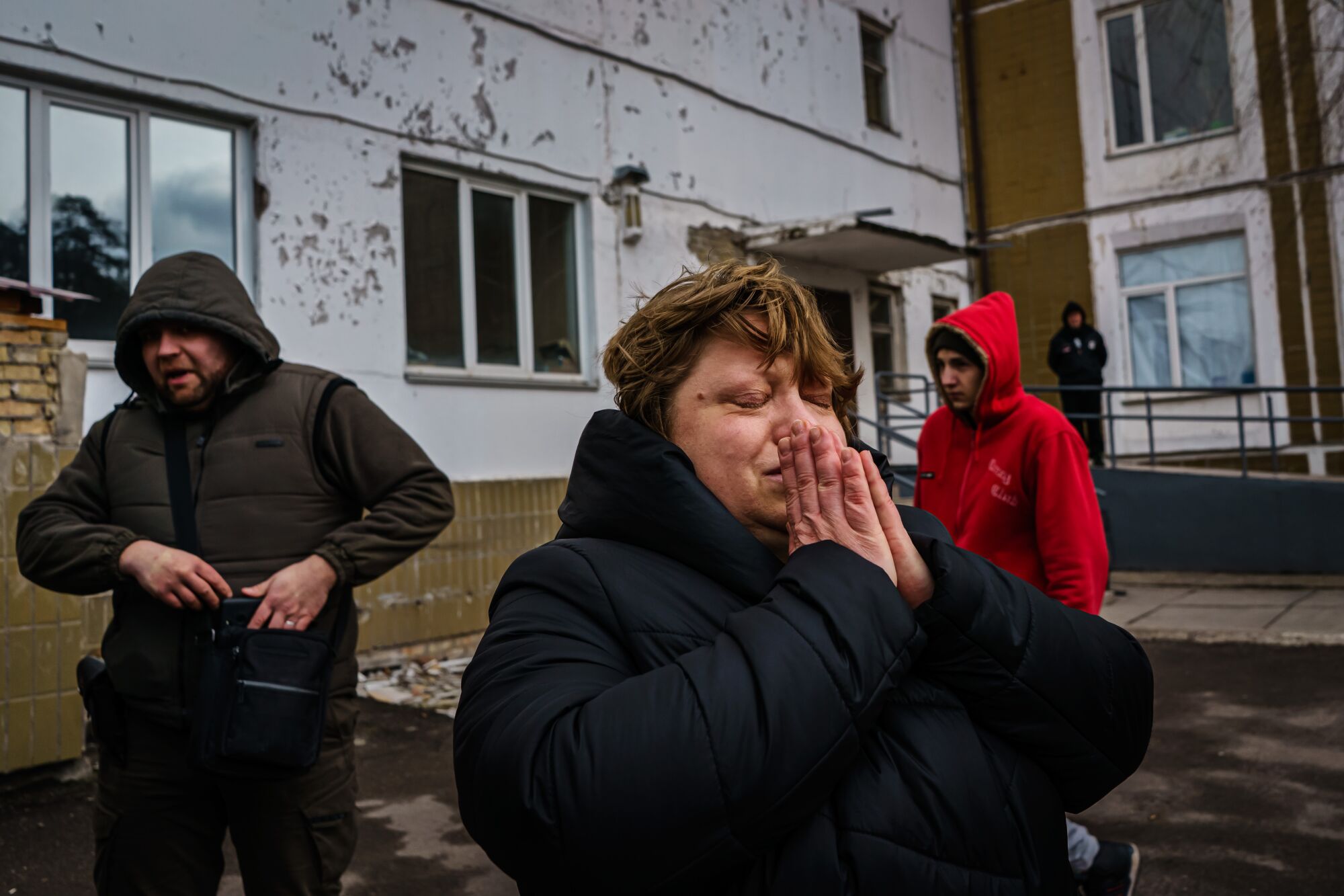 A woman holds her hands in prayer