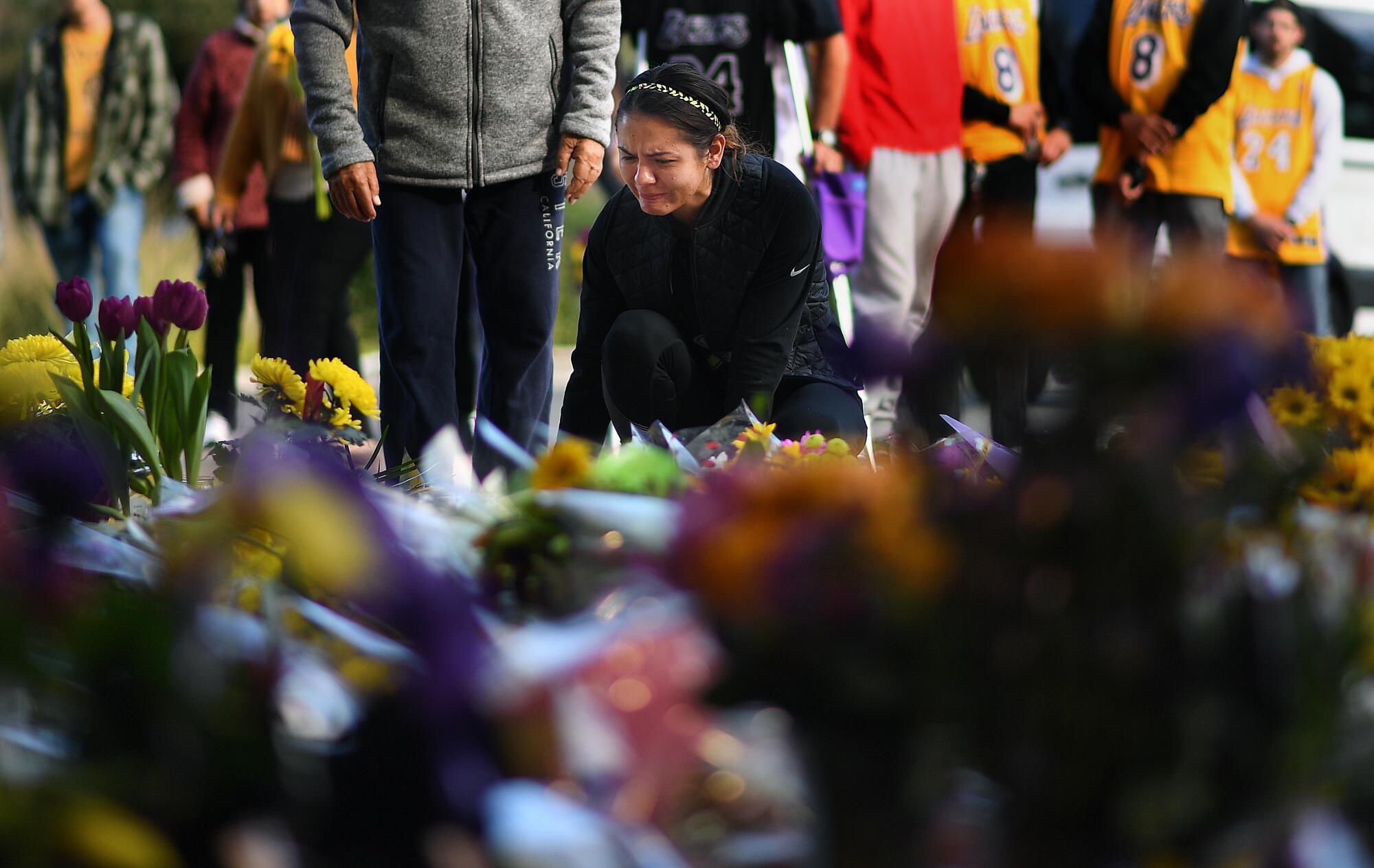 Sophy Peniche of Camarillo pays her respects at a makeshift memorial outside of Kobe Bryant’s Mamba Sports Academy.