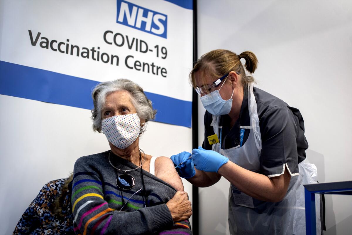 Dr. Doreen Brown receives her first dose of the COVID-19 vaccine made by Pfizer and BioNTech at Guy's Hospital in London.