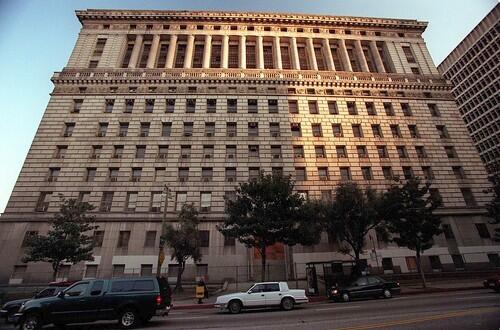 Late afternoon sun falls across the Broadway side of the old Hall of Justice Building. The building has a storied past, temporarily housing such inmates as Charles Manson and actor Robert Mitchum.