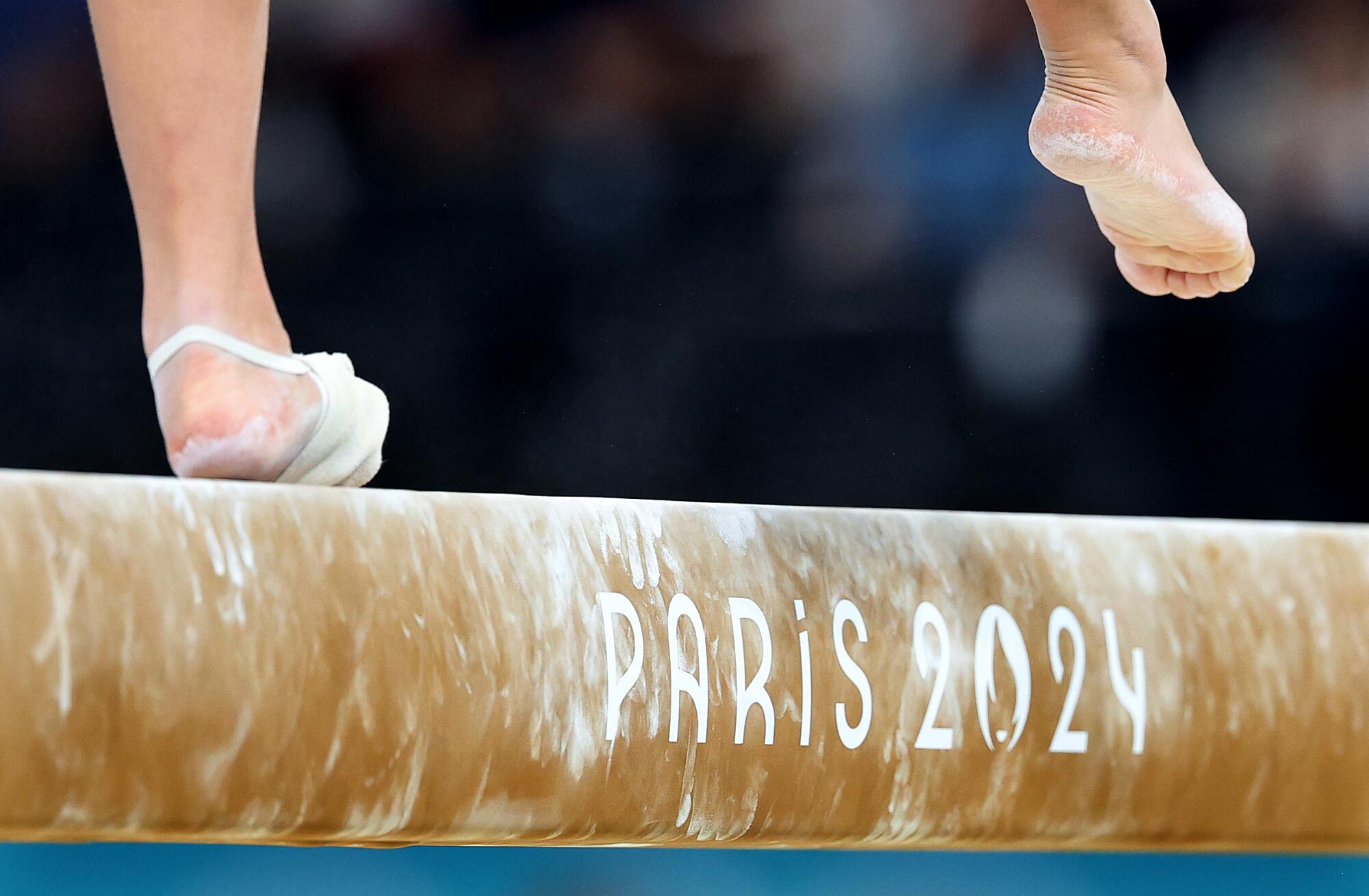 Hezly Rivera loses her balance on the beam during qualification.