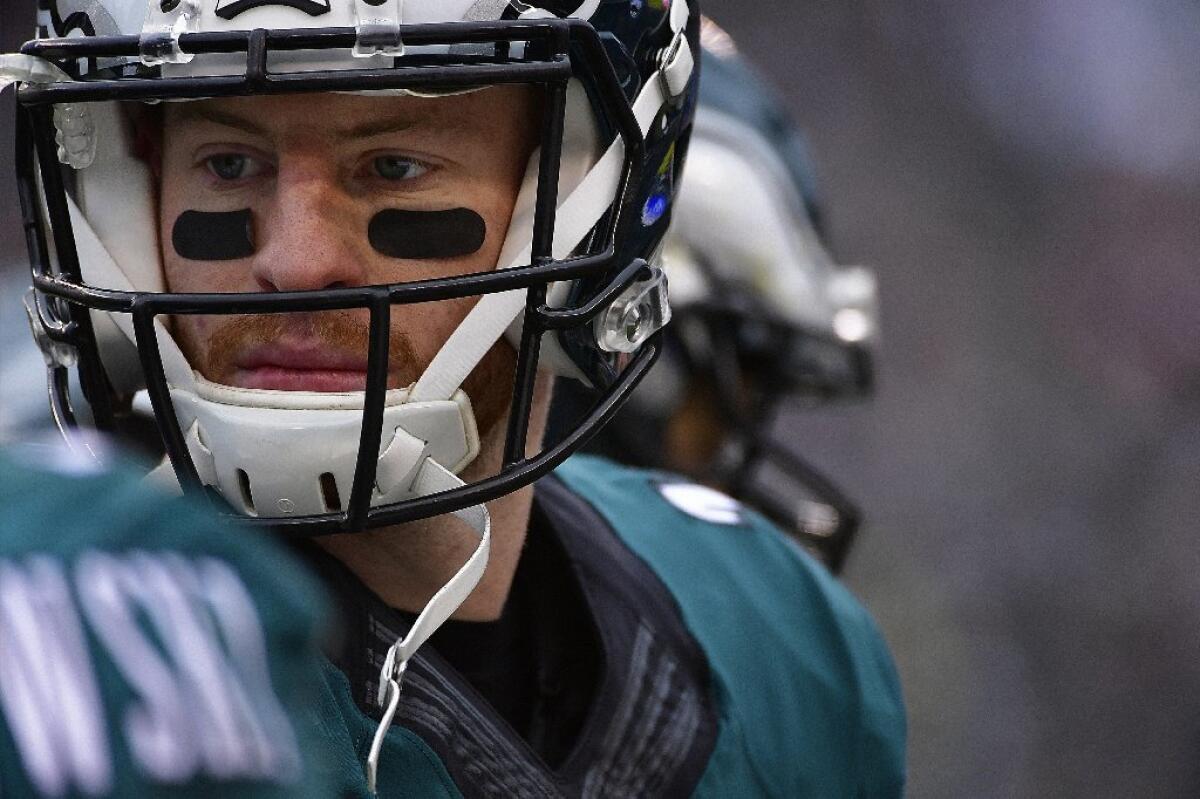 Eagles quarterback Carson Wentz listens to his coaches on the sideline during a game against the Redskins last season.