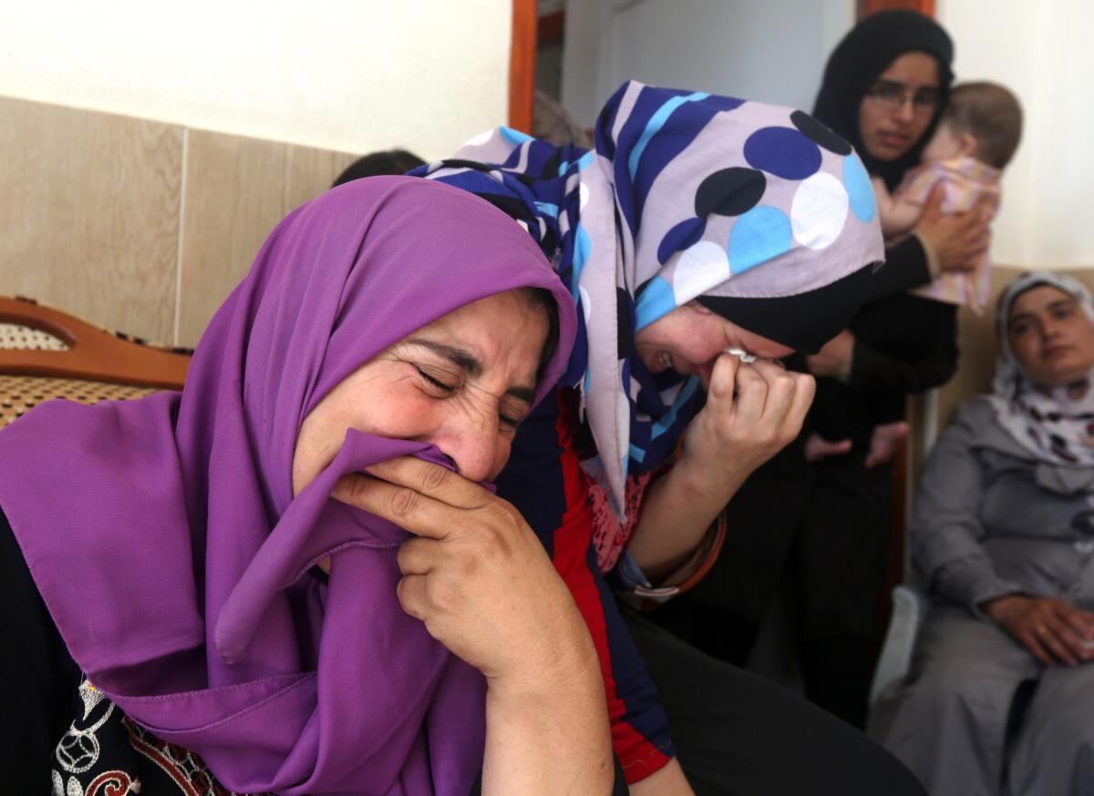 Relatives and friends of Saad Dawabshe mourn at his funeral in the West Bank village of Duma.
