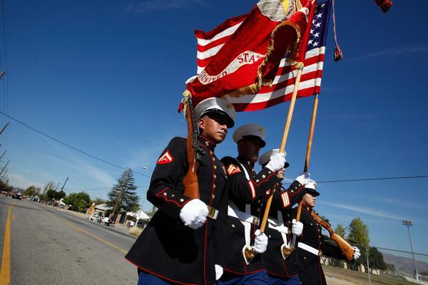 A Marine Corps Honor Guard marches along Laurel Canyon Boulevard on Monday during the San Fernando Valley Veterans Day Parade.
