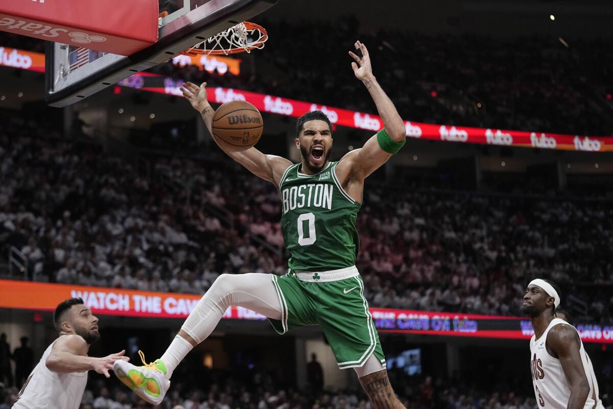 Boston Celtics forward Jayson Tatum shouts after dunking the ball 