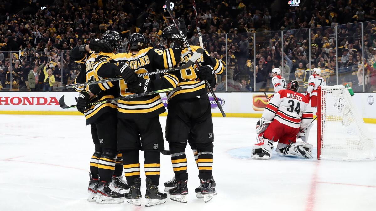 Boston Bruins' Marcus Johansson (90) celebrates with teammates after scoring a third period goal against the Carolina Hurricanes in Game 1 of the Eastern Conference final during the NHL playoffs in Boston.
