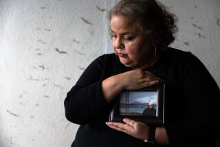 Los Angeles, CA - July 13: Portrait of Sandra Munoz, a celebrated civil rights attorney in Los Angeles. She is holding a photo of her husband Luis on January 3, 2024, in Los Angeles, CA. They have been separated since 2015. Luis, who was undocumented, applied for a waiver of his illegal entry to seek citizenship after they got married. The final step was considered a formality -- he would go back to El Salvador for an interview at the U.S. consulate there and fly back to the U.S. once it was approved. Instead, it was denied. When their lawyers pressed the government for why, the State Department admitted that his tattoos -- of La Virgen de Guadalupe, a tribal design and theatrical masks -- were among the reasons they had found him to be an MS-13 gang member, an assertion he vehemently denies. Last year, the 9th Circuit sided with the couple, but the Biden administration appealed to the Supreme Court. The high court is expected to decide next month whether to take up the case, which would have ripple effects for any immigrant seeking to challenge the government's views of their character. (Francine Orr / Los Angeles Times)