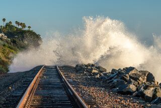 Southbound Metrolink train was stopped in San Clemente by ocean waves washing over the tracks.