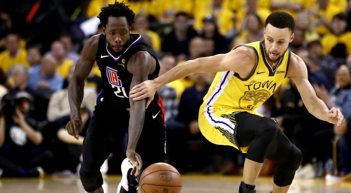 Patrick Beverley of the Clippers steals the ball from Stephen Curry of Golden State Warriors during Game 2.