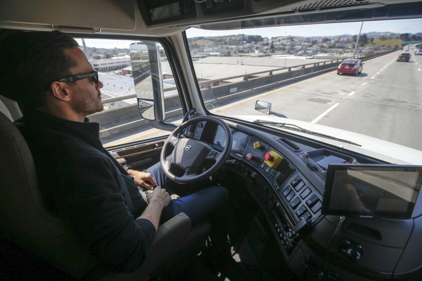 FILE - Matt Grigsby, senior program engineer at Otto, takes his hands off the steering wheel of a self-driving, big-rig truck during a demonstration on the highway, Thursday, Aug. 18, 2016, in San Francisco. Gov. Gavin Newsom has vetoed a bill that would have required human drivers to be onboard self-driving trucks, a measure that union leaders and truck drivers said would save hundreds of thousands of jobs. The legislation vetoed Friday, Sept. 22, 2023, night would have banned self-driving trucks weighing more than 10,000 pounds (4,536 kilograms), vehicles from UPS delivery vans to massive big rigs, from operating on public roads unless a human driver is on board. (AP Photo/Tony Avelar, File)