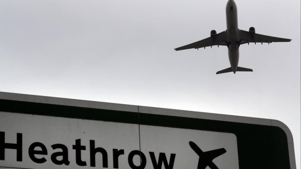 A plane takes off over a road sign near Heathrow Airport in London. JetBlue Airlines plans to fly to London in 2021 but getting into Heathrow Airport, London's most popular airport, may be difficult.
