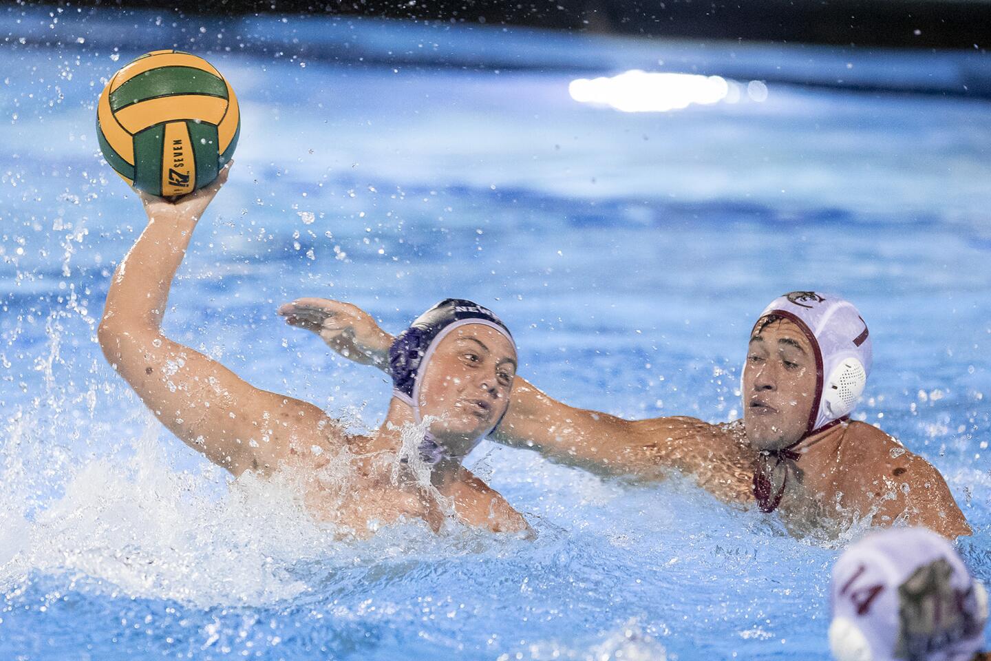 Newport Harbor's Jake Liechty takes a shot under pressure from Oaks Christian's Alika Naone during a CIF Southern Section Division 1 playoff game at Woollett Aquatic Center on Wednesday, November 7.