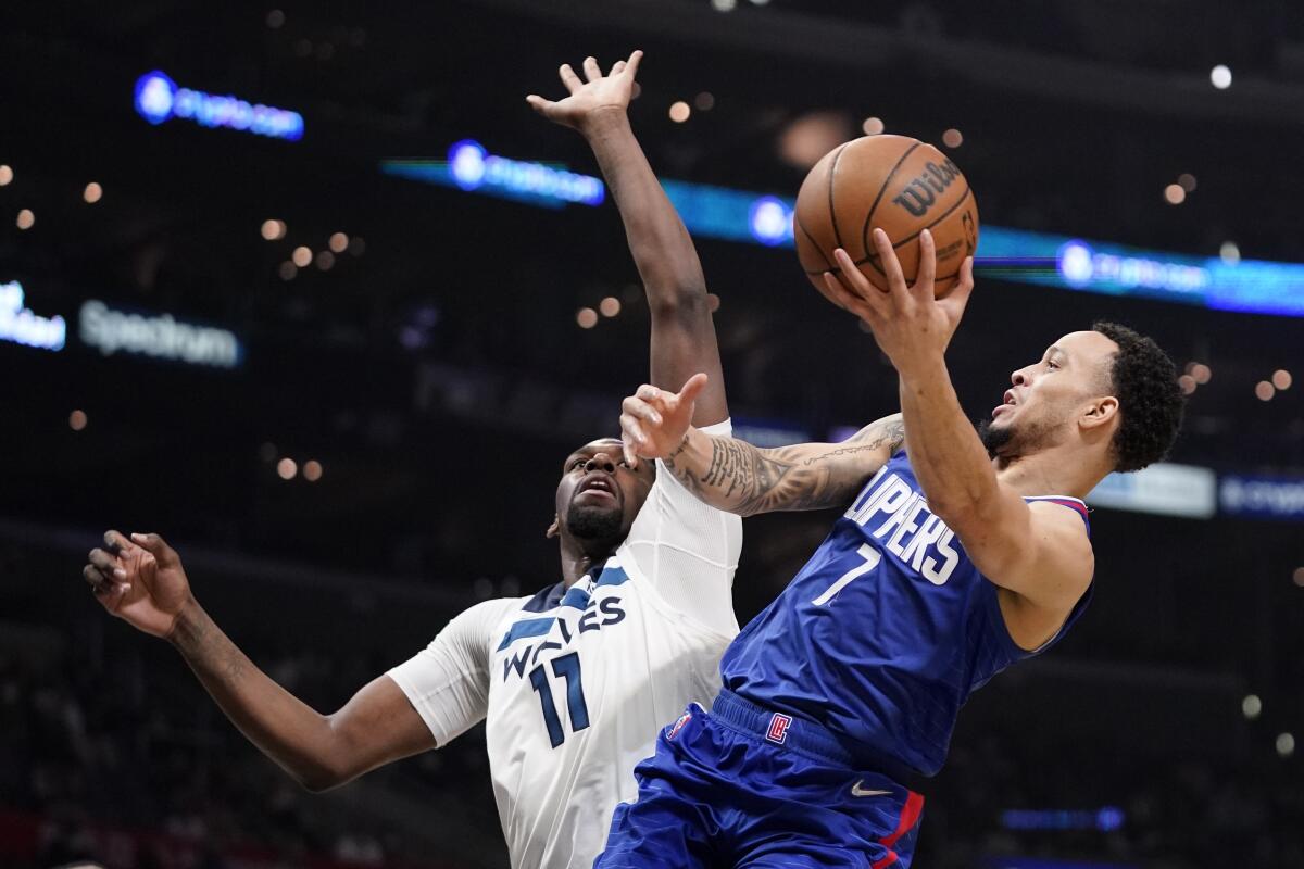 Clippers guard Amir Coffey shoots as Minnesota Timberwolves center Naz Reid defends.