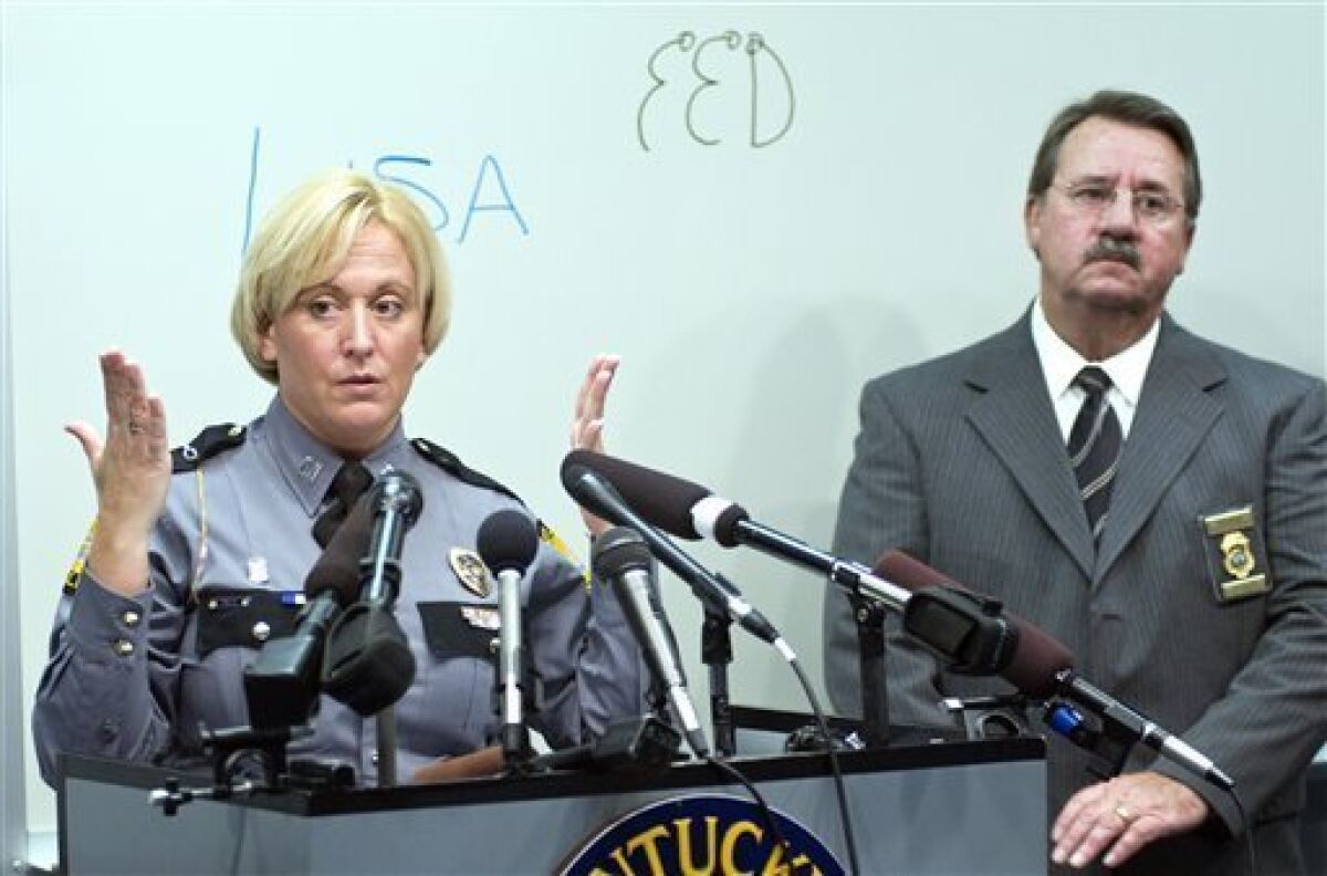 Kentucky State Police Capt. Lisa Rudzinski, left, and Mike Wilder, Executive Director of the Kentucky State Medical Examiners office, right, answer questions during a news conference, Tuesday, Nov. 24, 2009, at the Kentucky State Police Central Forensic Laboratory in Frankfort, Ky. The Kentucky census worker found naked, bound with duct tape and hanging from a tree with "fed" scrawled on his chest killed himself but staged his death to make it look like a homicide, authorities said Tuesday. (AP Photo/Brian Bohannon)