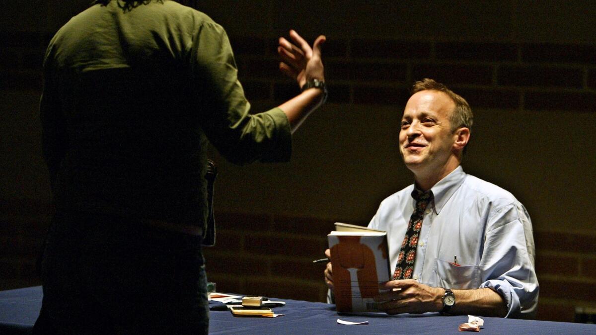 David Sedaris signing books at Royce Hall in 2004. (Ricardo DeAratanha / Los Angeles Times)
