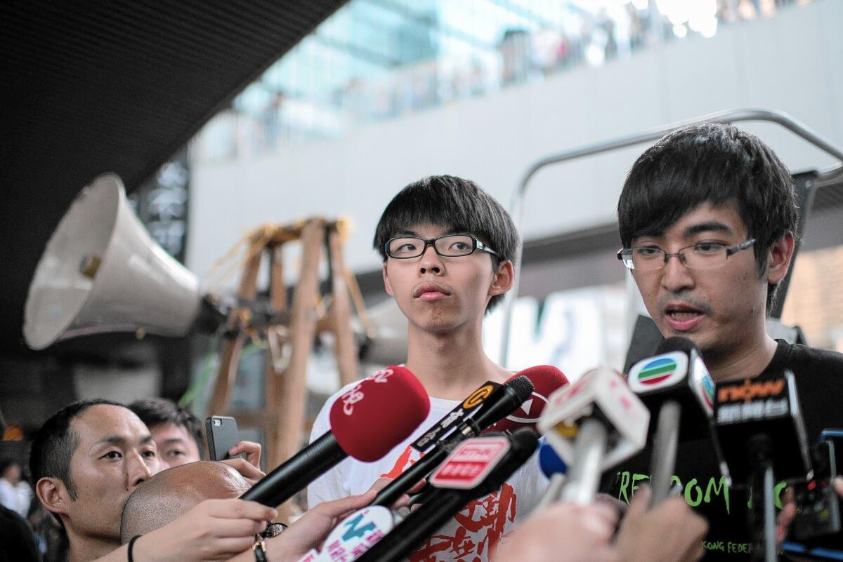 Alex Chow, head of the Hong Kong Federation of Students, speaks to reporters on Oct. 4. Next to him is Joshua Wong, 17, leader of a high school activist group.