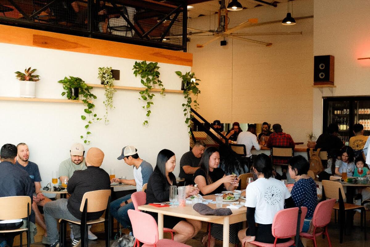Interior of Homage Brewing with customers seated at tables