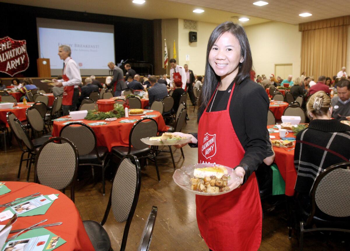 Tuany Vo helps serve breakfast during the 2015 Kettle Kick Off breakfast at the Glendale Civic Auditorium in Glendale on Friday, November 20, 2015.