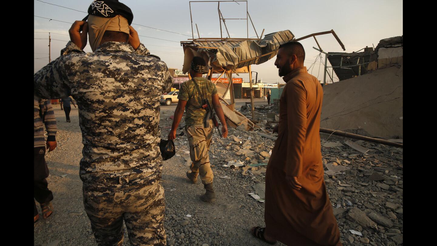 Iraqi soldiers now control the town of Qayyarah, where bombing destroyed many shops.
