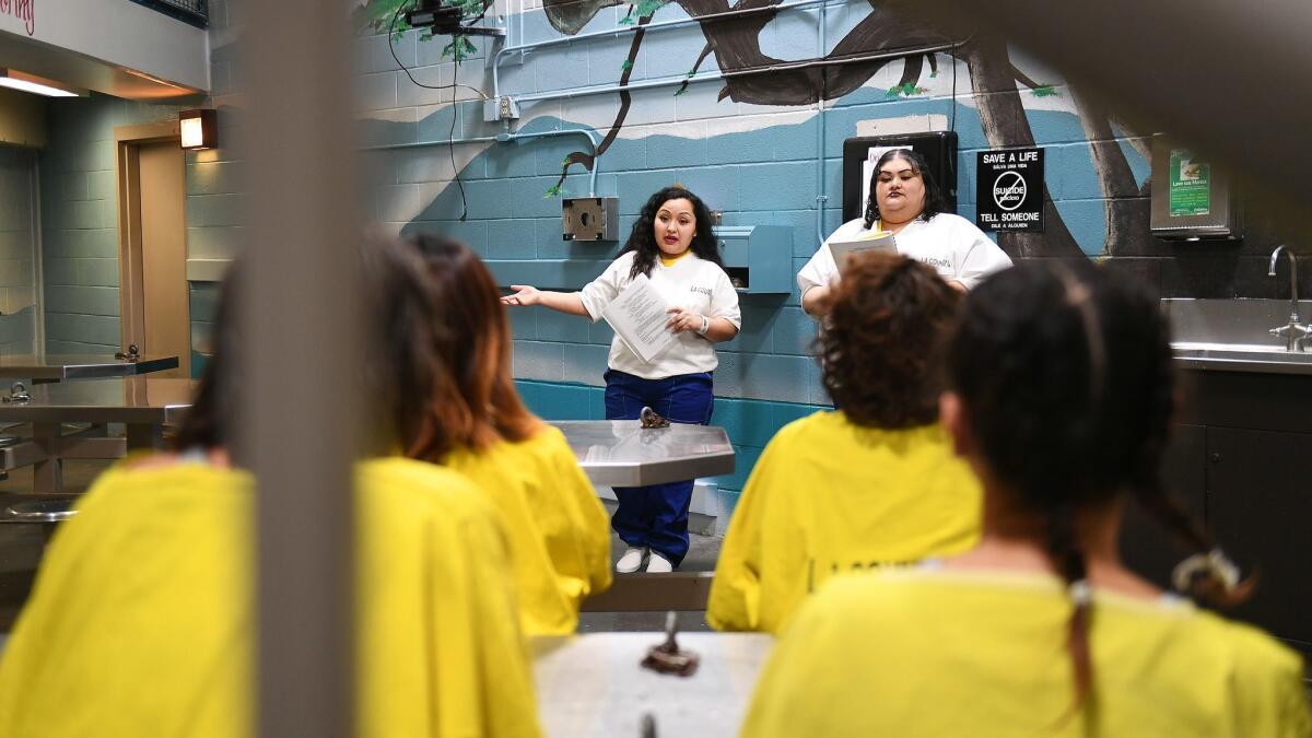 Karla Espinoza, left, and Josefina Ramirez speak to other inmates at the jail.