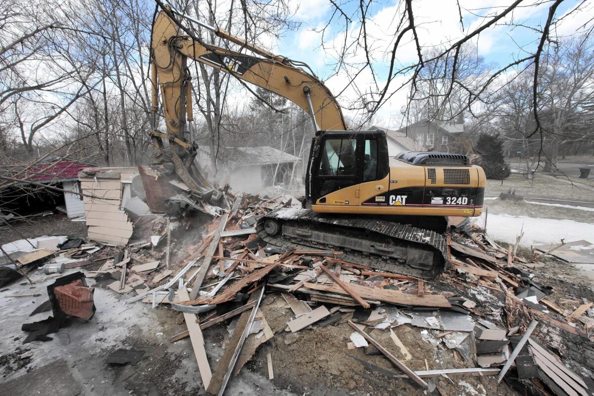 A vacant home is demolished in Detroit in March.