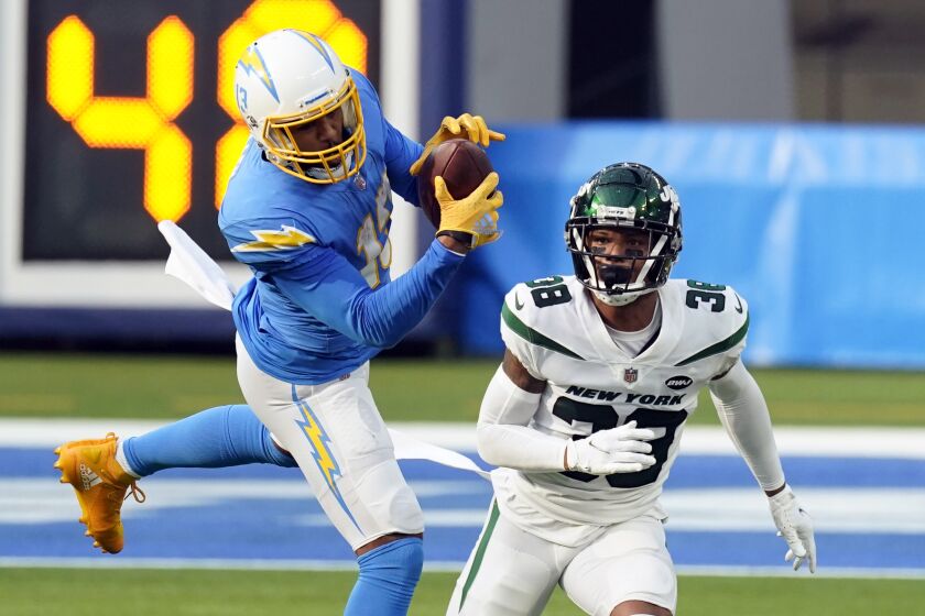 Los Angeles Chargers wide receiver Keenan Allen, left, catches the ball in front of New York Jets.