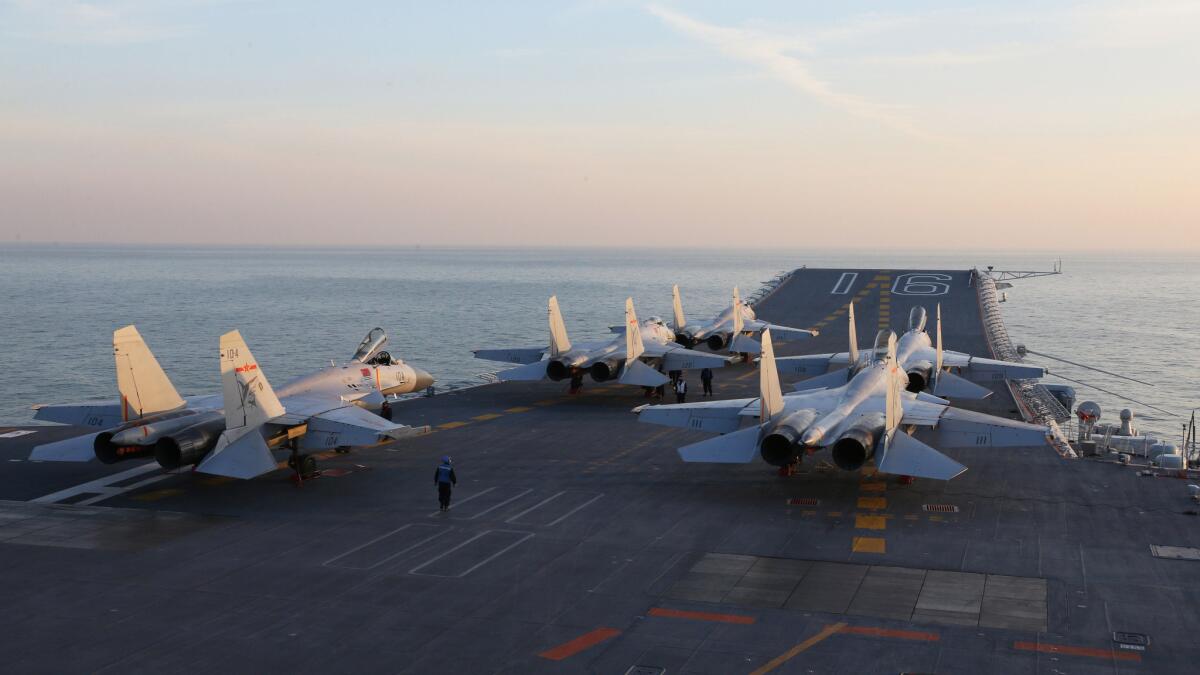Chinese J-15 fighter jets are seen waiting on the deck of the aircraft carrier Liaoning in December 2016 during military drills in the Bohai Sea, off China's northeastern coast, as tensions with the U.S. and Taiwan escalate.