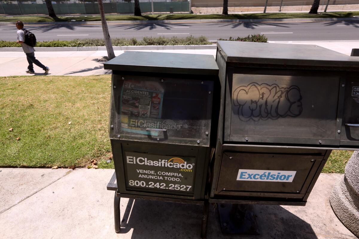 An empty news rack that used to sell Spanish language newspaper Excelsior still remains standing in Santa Ana on June 26.
