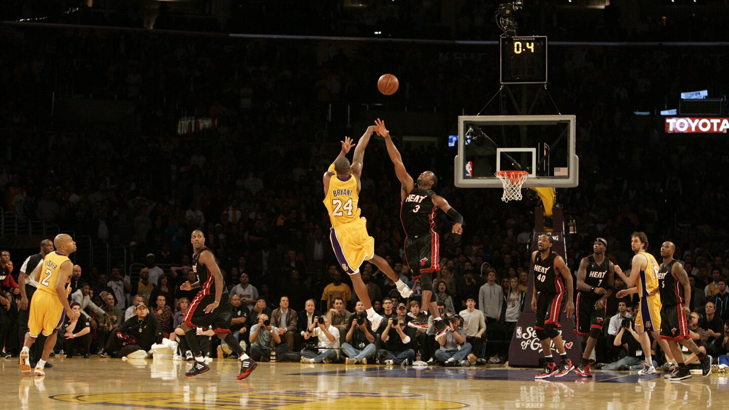 Lakers star Kobe Bryant shoots over Miami Heat guard Dwyane Wade to score the winning basket with less than a second remaining in a 108-107 victory at Staples Center on Dec. 4, 2009.