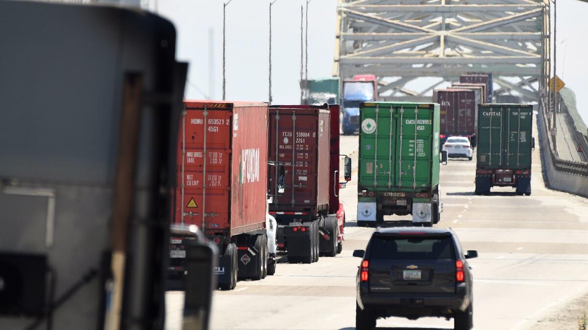 Trucks approach the Gerald Desmond Bridge at the Los Angeles-Long Beach port complex.
