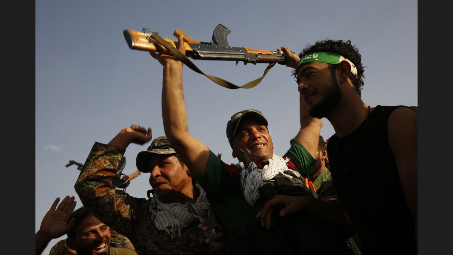 Militiamen chant before going into battle alongside Iraqi army forces as they fight against Islamic State near Mosul.