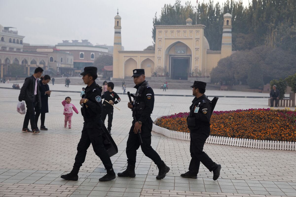Uighur security personnel patrol near Id Kah Mosque in Kashgar, in the Xinjiang region, in 2017.