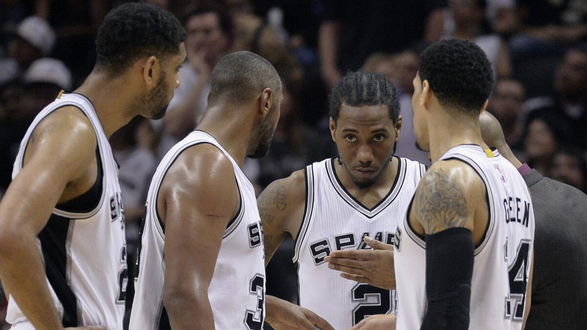 San Antonio Spurs teammates (from left) Tim Duncan, Boris Diaw, Kawhi Leonard and Danny Green talk during the second half of Sunday's loss to the Clippers in Game 4 of the Western Conference quarterfinals.